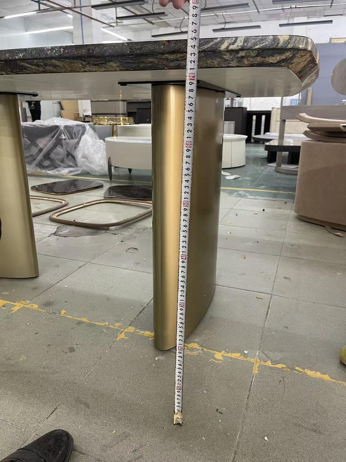 Measuring a marble table base at the factory