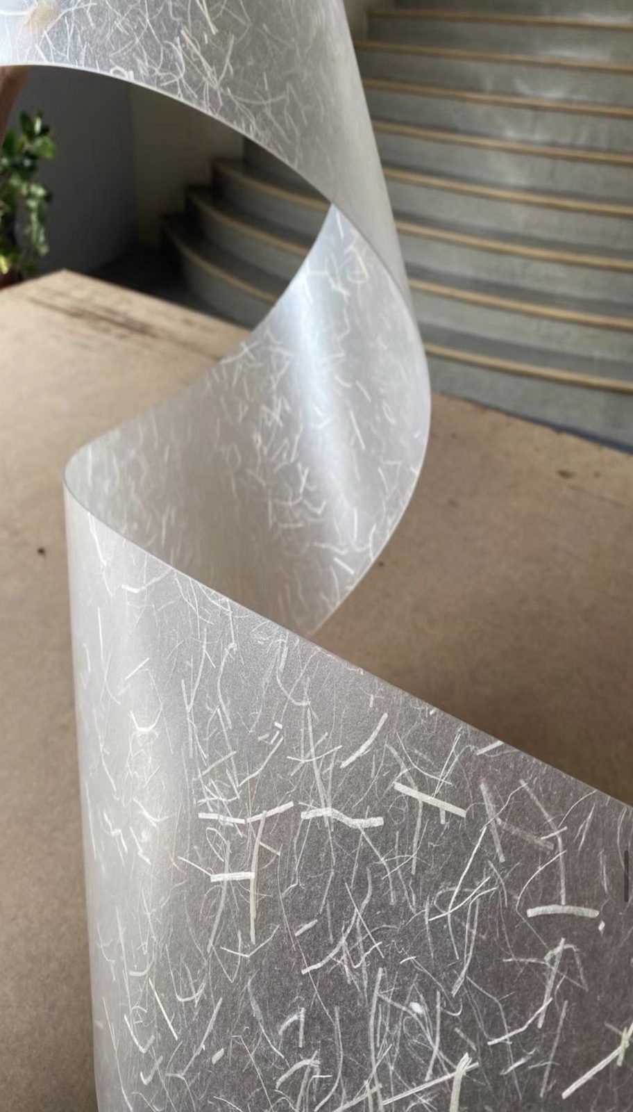 Textured wall covering sample unrolled on a table